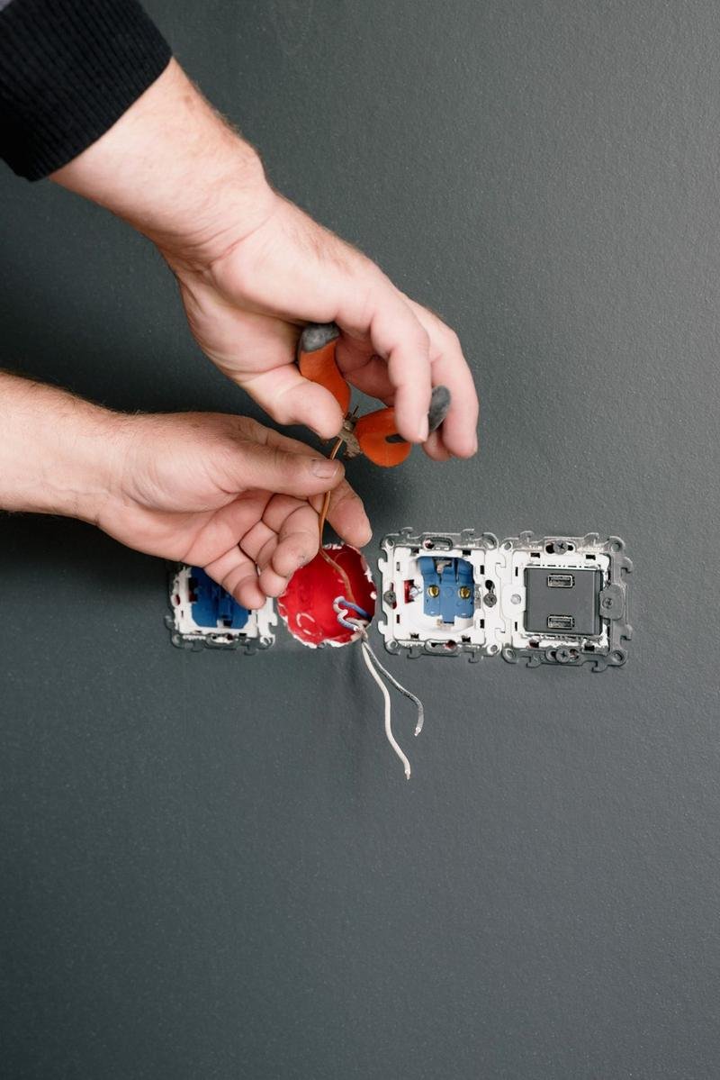 Modular switch and socket being installed on a wall