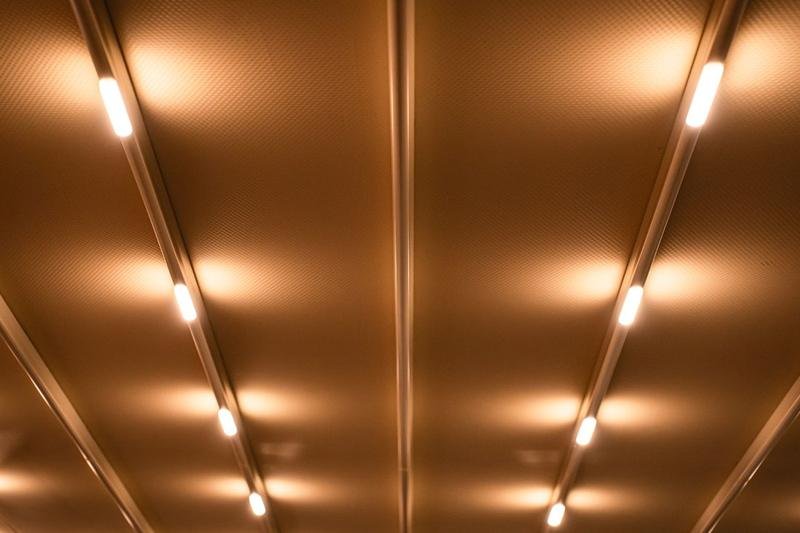 Warm linear LED ceiling lighting in a modern interior